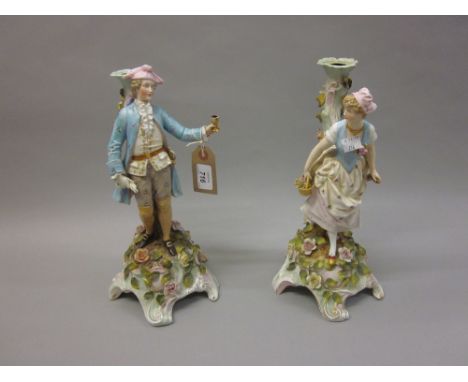 Pair of Continental porcelain figural and floral encrusted candelabra bases
