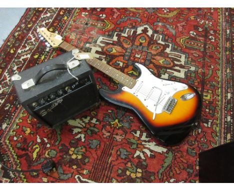 Fender Squire SP10 amplifier together with an Encore six string guitar