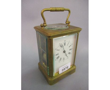 Early 20th Century gilt brass carriage clock, the enamel dial with Arabic and Roman numerals, with a two train movement strik