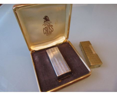 Dunhill gold plated cigarette lighter together with a Cross silver plated cigarette lighter in original box