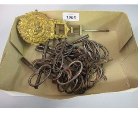 Collection of thirty seven various clock winding keys and a pendulum