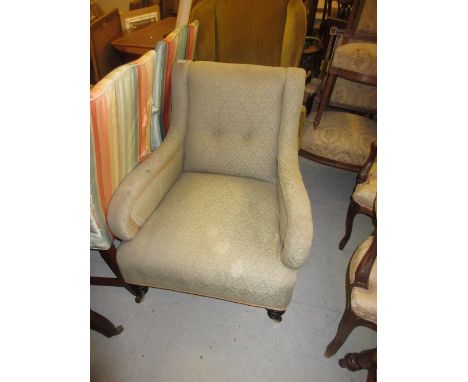 Late 19th / early 20th Century library armchair on turned tapering supports with brass caps and ceramic casters