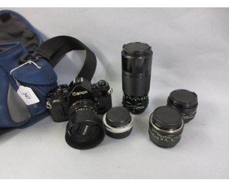 Canon A1 camera outfit with five various lenses and manual in blue holdall CONDITION REPORT The film does advance, the lever 