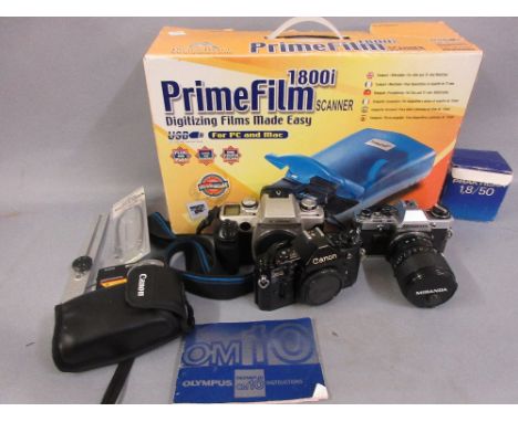 Quantity of various cameras including Canon A1 and another Canon BOS50E, Olympus, prime film 1800i scanner in original box an
