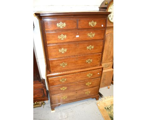 George III mahogany tallboy, the moulded cornice above two short and six long graduated drawers with brass handles raised on 