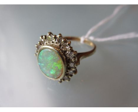 Oval opal and diamond cluster ring