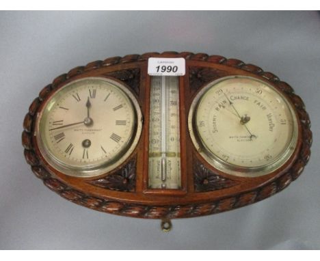 Late 19th or early 20th Century clock barometer in an oval carved mahogany case with central thermometer, signed Whyte Thomso