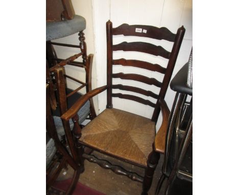 George III ladder back elbow chair with a rush seat on turned supports