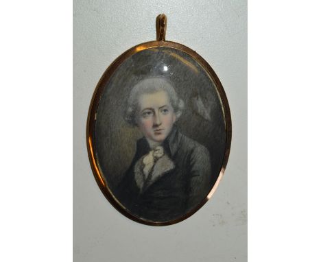Oval gold plated framed portrait miniature of a bewigged gentleman