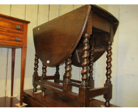 1930's Oval oak gate leg dining table on barley twist supports