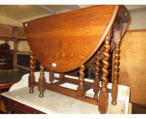 Early 20th Century oak oval gate leg table on barley twist supports together with an oak bureau