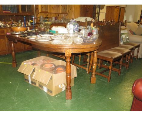 OAK EXTENDING DINING TABLE WITH TWO LEAVES TOGETHER WITH A SET OF EIGHT LADDER BACK CHAIRS INCLUDING TWO CARVERS WITH UPHOLST