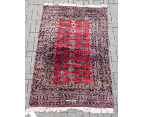 zzz A Bokhara rug. signed, 210 x 122cm A Bokhara rug. signed, 210 x 122cmThis lot has been imported from outside the UK and i