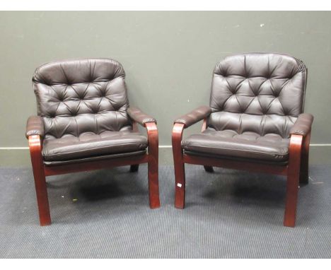 zzz A pair of Danish brown leather upholstered easy armchairs A pair of Danish brown leather upholstered easy armchairsThis l
