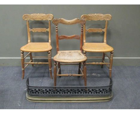 A pair of caned and carved William IV style chairs together with a 20th century brass standard lamp raised on stylised leaf f