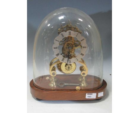 A Victorian gilt brass skeleton timepiece with single train movement and wavy edged silvered dial with black enamel Roman num