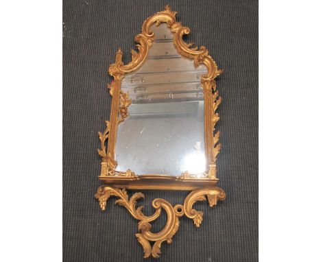 A Chippendale rococo style gilt wood wall mirror with shelf 117 x 52cm