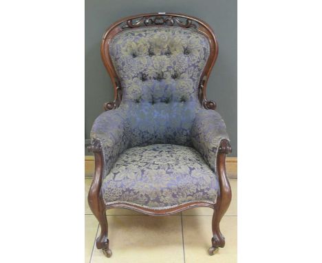 A Victorian mahogany button back armchair with pierced top rail on cabriole legs