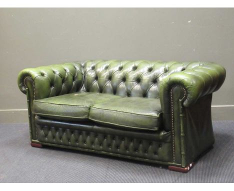 A modern button back Chesterfield type two seater sofa upholstered in green faux-leather, 67 x 160 x 87cmHawks Club Cambridge