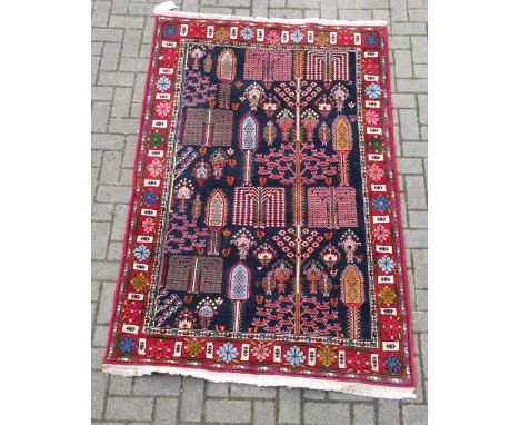 zzz A hand-woven blue ground rug with floral decoration  A hand-woven blue ground rug with floral decoration 209 x 131cmThis 