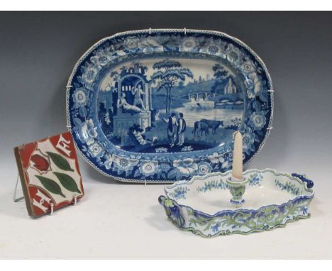 A good blue and white pearl ware meat plate; together with a Minton encaustic tile, a Mosanic tin glazed earthenware centrepi