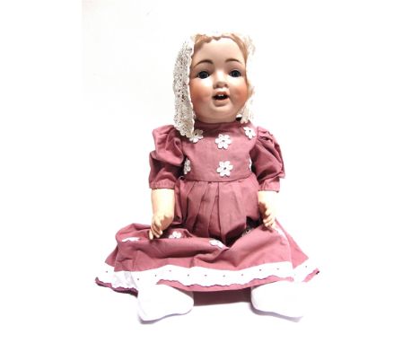 A KLING &amp; CO. BISQUE SOCKET HEAD DOLL  lacking wig, with sleeping blue glass eyes and an open mouth with two upper teeth 