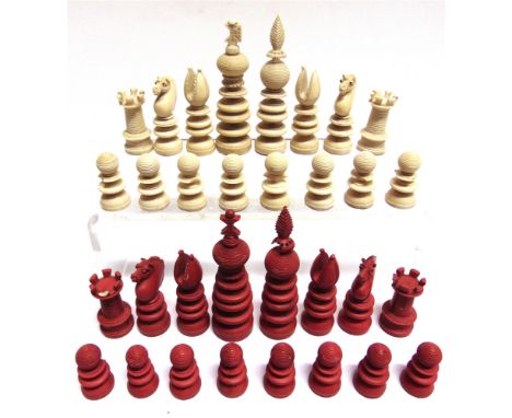 A 19TH CENTURY LUND PATTERN IVORY CHESS SET  natural white and stained red, the kings 9cm high (many pieces with damage, some