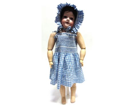 AN ARMAND MARSEILLE BISQUE SOCKET HEAD DOLL  affectionately known as 'Annie', with a brown wig, sleeping brown glass eyes, an