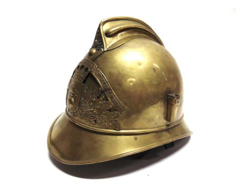 A FRENCH BRASS FIREMAN'S HELMET  of regulation pattern, bearing a pierced St. Jean Le Vieux (Pyrennes Dept.) helmet plate, co