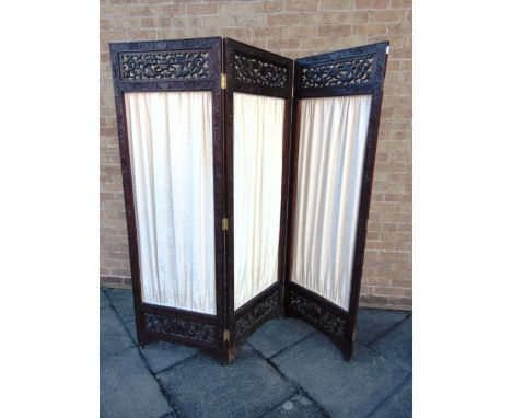 AN ORIENTAL CARVED THREE-FOLD SCREEN  with central fabric panels. Height 184cm width of each panel 61cm.