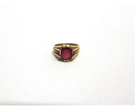A SYNTHETIC RUBY SET RING with Egyptian marks to the outside of the shank, 6.6g gross