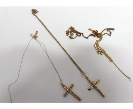 A CROSS AND CHAIN a crucifix on a chain; a 9 carat gold chain; and another chain