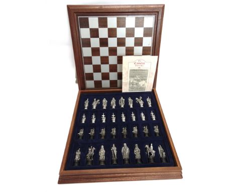 A DANBURY MINT CAMELOT CHESS SET  of brushed pewter, the kings 7.5cm high, boxed, the box with a playing board lid, complete 
