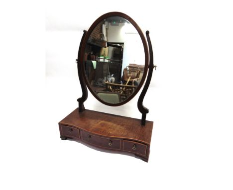 A MAHOGANY TOILET MIRROR  the serpentine front base fitted with three drawers, 48cm wide 20cm deep 63cm high
