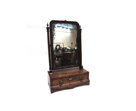 A WALNUT VENEERED TOILET MIRROR  the base with drawer to the shaped front, 36cm wide 18cm deep 59cm high