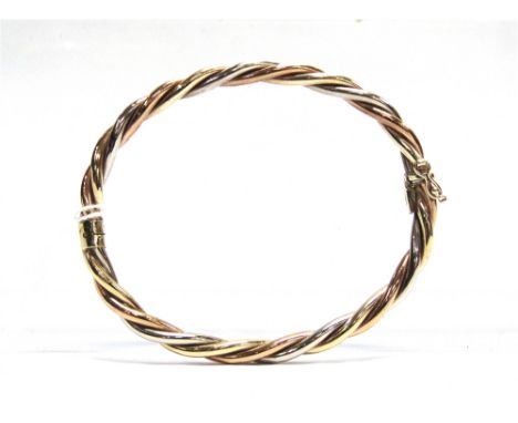 A 9 CARAT GOLD HINGED BANGLE of hollow three colour barley twist design, internal diameter 6.5cm, 10.7g gross