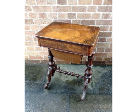 A VICTORIAN WALNUT WORK TABLE  with single fitted drawer and sliding work pouch under and raised on four outswept supports wi