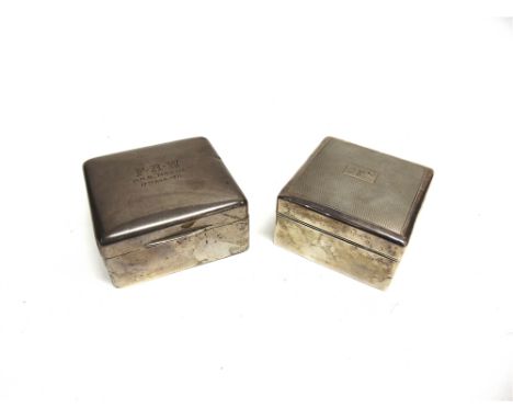 A SILVER CIGARETTE BOX  inscribed 'H.M.S. Hogue' 1911; and another similar engine turned example 