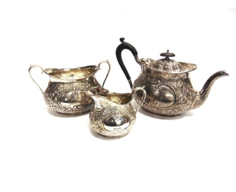 A LATE VICTORIAN SILVER THREE PIECE TEA SERVICE  by Mappin Brothers, Lon 1893, of oval outline, embossed with foliage, cartou