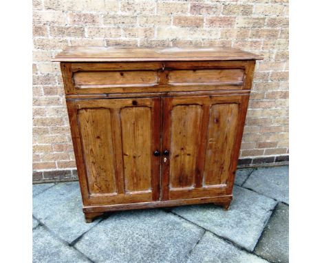 A PITCH PINE CUPBOARD  with drawer above pair of panelled doors on bracket feet, 100cm wide 45cm deep 109cm high