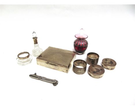 A PLAIN SILVER CIGARETTE BOX  wooden lined; a pair of silver engine turned napkin rings; a silver mounted glass salt; a silve