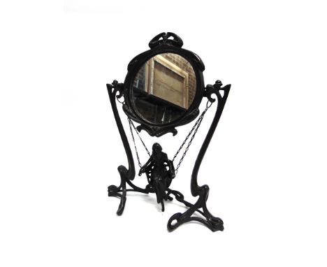 AN ART NOUVEAU STYLE DECORATIVE MIRROR  modelled as a girl in a swing, stamped to reverse 'ERTE PARIS 1907' within a triangle