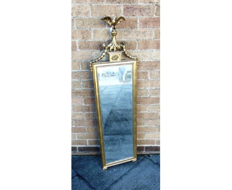 A GILT FRAMED BEVEL EDGE PIER MIRROR  with eagle surmount, 40cm wide 128cm high