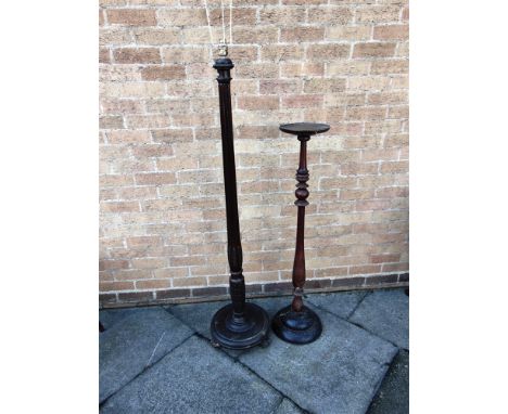 A MAHOGANY TORCHERE  on turned pillar support, the tray top 23cm diameter, 105cm high; together with a mahogany standard lamp