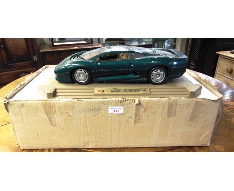 FIVE 1/24 SCALE MAISTO DIECAST MODEL CARS  each boxed; together with a 1/12 scale Maisto Jaguar XJ220, on its display plinth,