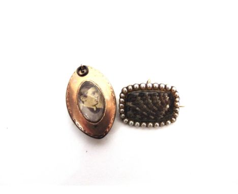 A MOURNING PENDANT with hair and seed pearls under glass, locket back now with a photograph; with a split pearl border mourni
