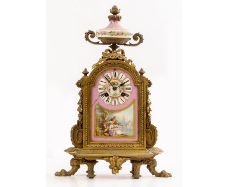 A CONTINENTAL GILT SPELTER MANTLE CLOCK the case surmounted by an urn and with further ribbon tied decoration, floral swags, 