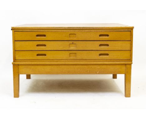 A MID 20TH CENTURY LIGHT OAK PLAN CHEST ON STAND with three long drawers and square legs, 122cm wide x 89cm deep x 73cm high