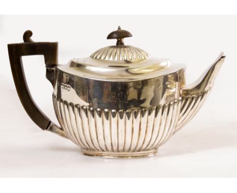 AN OVAL SILVER TEAPOT with gadrooned decoration and horn handle, approximately 476 grams in weight overall x 23.5cm long