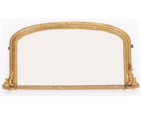 A 19TH CENTURY GILT FRAMED OVERMANTLE MIRROR with arching top and bun shaped ceramic supports 107cm wide x 57cm high
